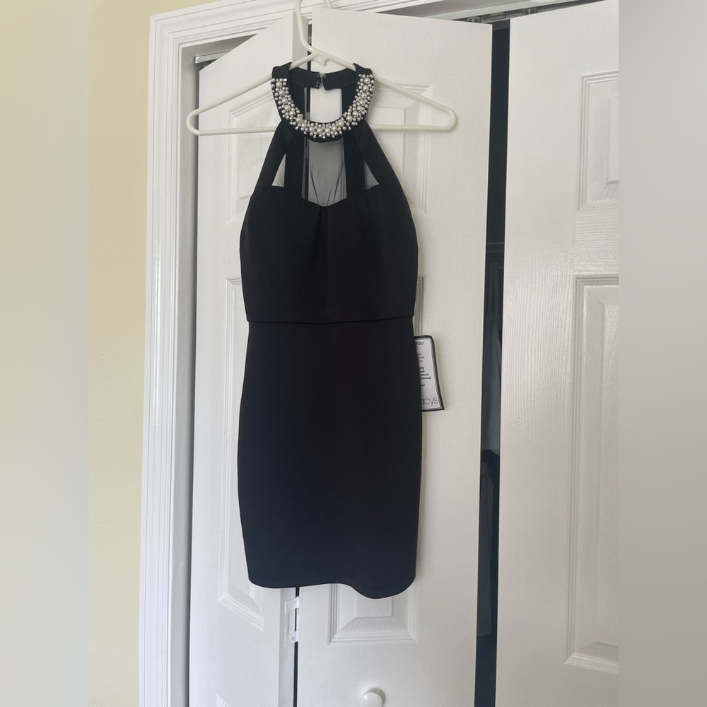 Black tight short dress. Size 3. Never worn before.